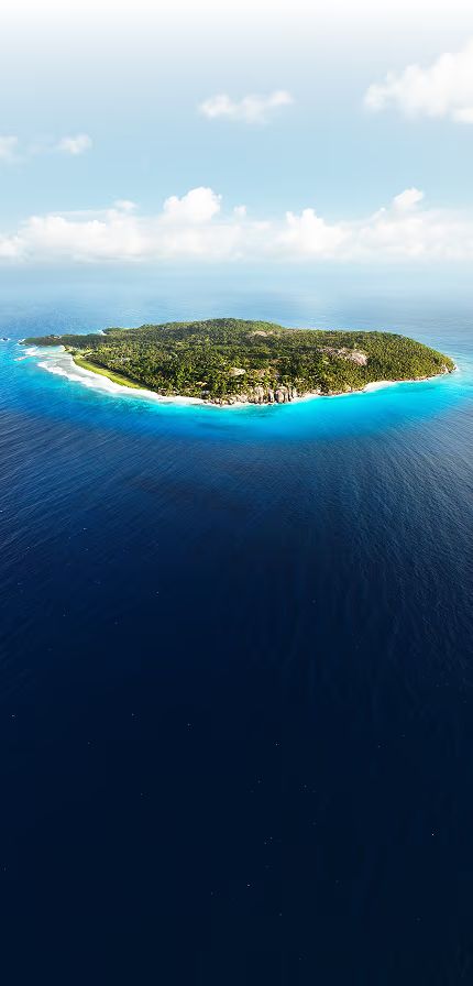 Aerial view of Fregate Island, a lush private island ringed by white-sand beaches in the turquoise Indian Ocean