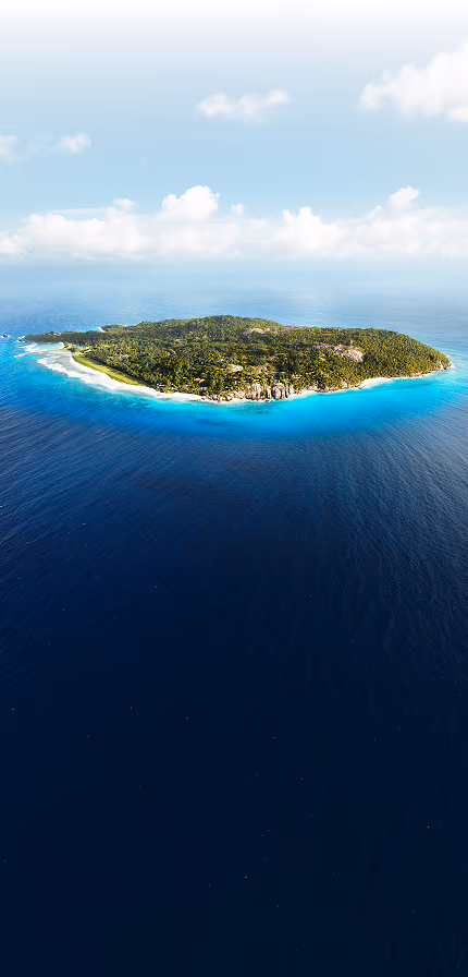 Aerial view of Fregate Island, a lush private island ringed by white-sand beaches in the turquoise Indian Ocean